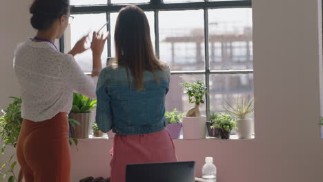 business women architects discussing construction project team of engineers brainstorming sharing ideas planning successful development enjoying window view in modern office