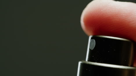 finger pressing spray bottle