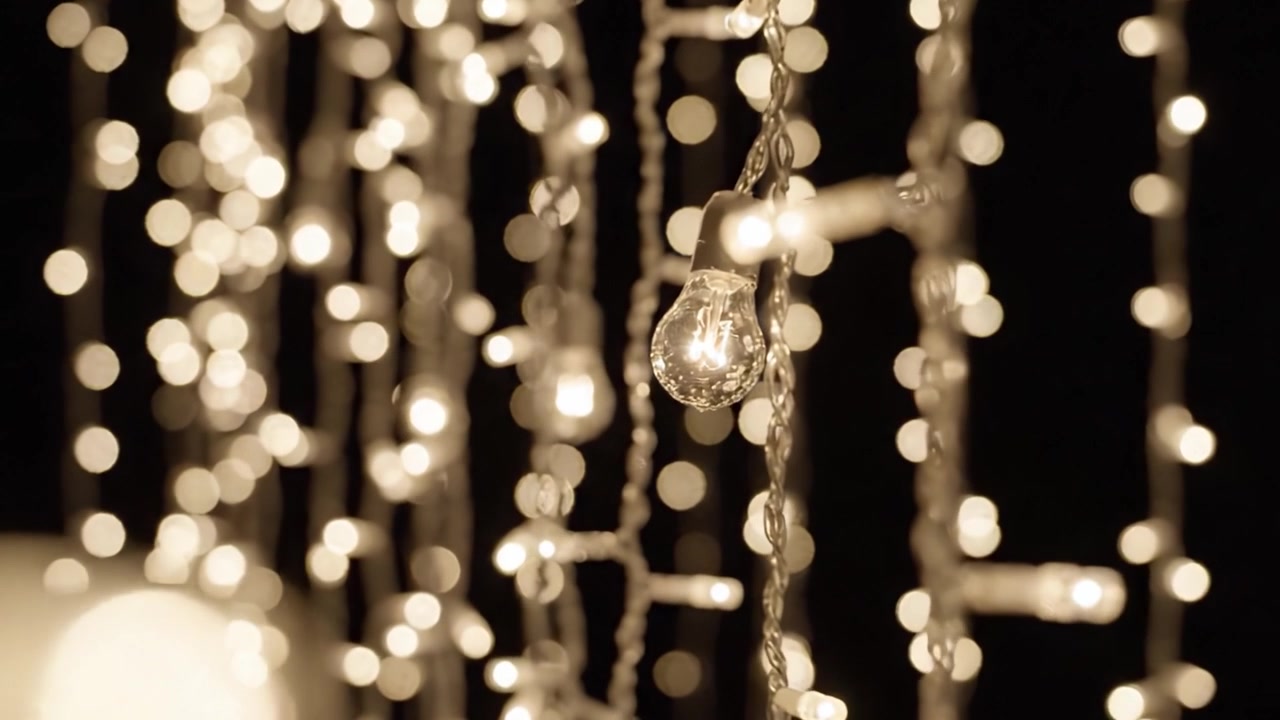 A Captivating Display of Glowing String Lights Sparkling Against a Dark Background, Creating a Magical and Enchanting Atmosphere of Warmth and Elegance