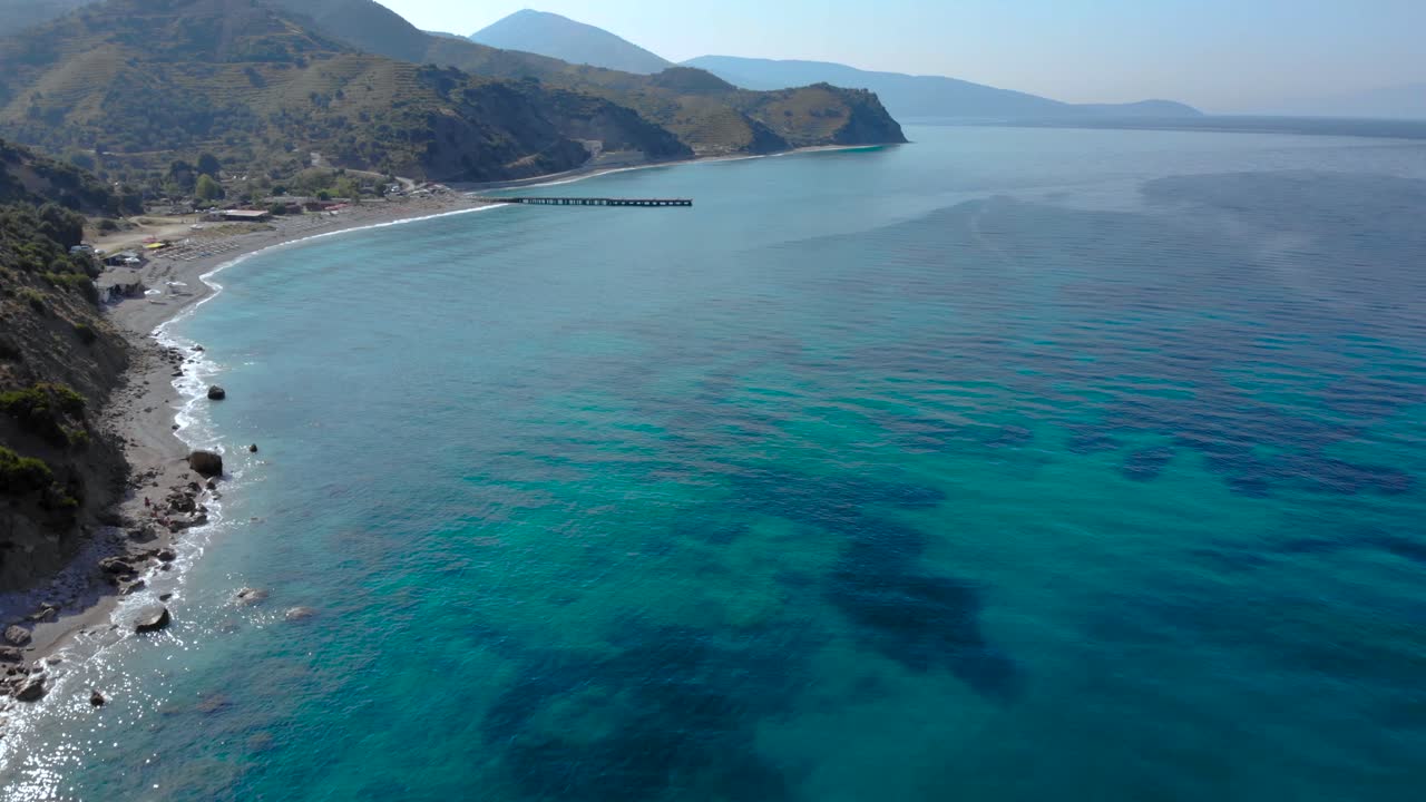 Colorful seascape with azure sea water on remote beach surrounded by green hills in Mediterranean