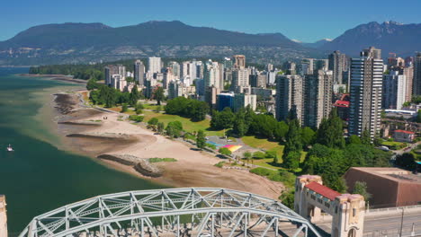 High-Rise-Buildings-On-False-Creek-Waterfront-Along-Sunset-Beach-Park-With-Burrard-Street-Bridge-In-Vancouver,-BC-Canada