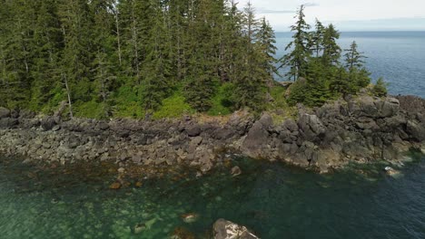 Aerial-Drone-Rising-Up-Along-the-Rocky-Coastline-of-Moresby-Island-near-Sandpit,-Grey-Bay,-Canada