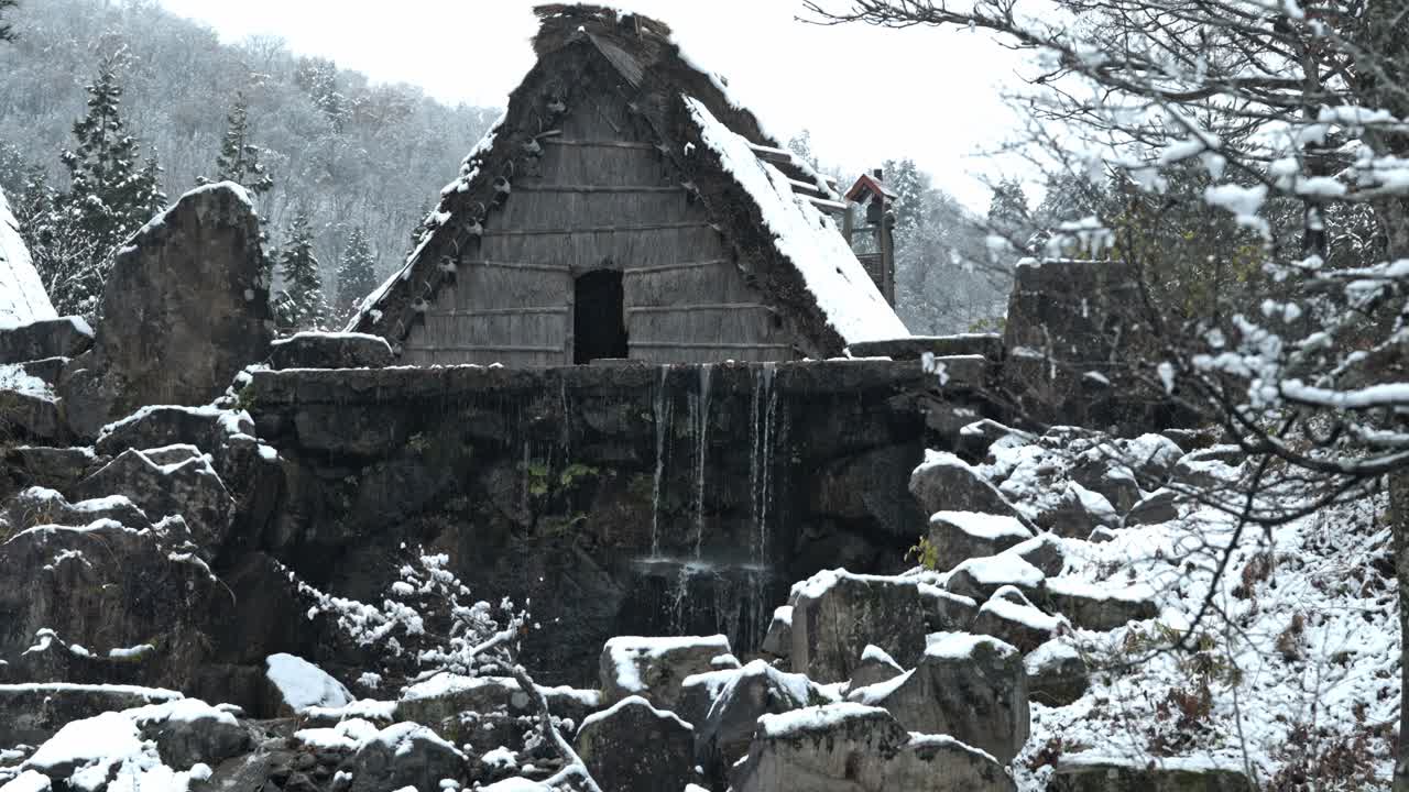 A stunning winter landscape of Shirakawa-go, Japan, as gentle snowflakes fall over the iconic thatched-roof houses.