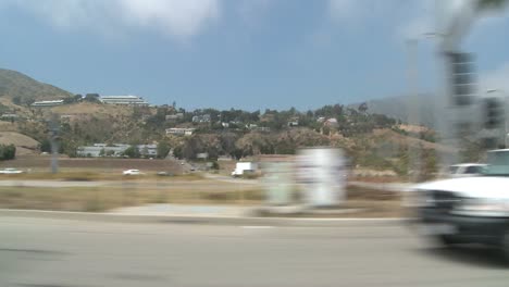 a car travels along pacific coast highway as seen through the side window 5