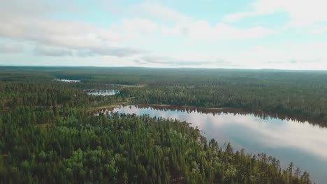 forward drone shot over forests and lakes in north finland