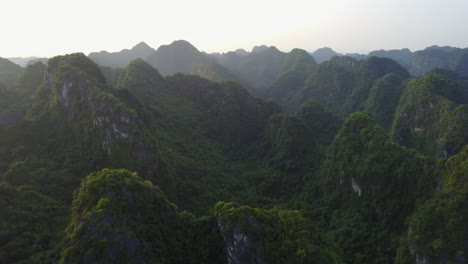 witness an amazing view of sunbeams breaking through the clouds and casting light over the dramatic peaks of the rock formations in ninh binh, vietnam, creating a breathtaking and ethereal scene