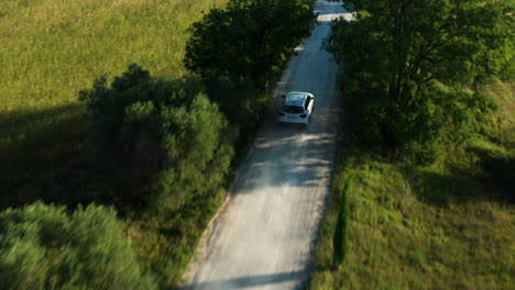 car drives through san quirico d'orcia region of tuscany