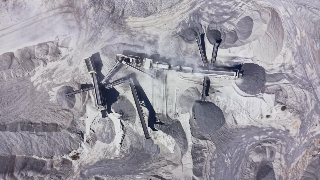 Granite quarry operations showing equipment and raw materials in a large mining area