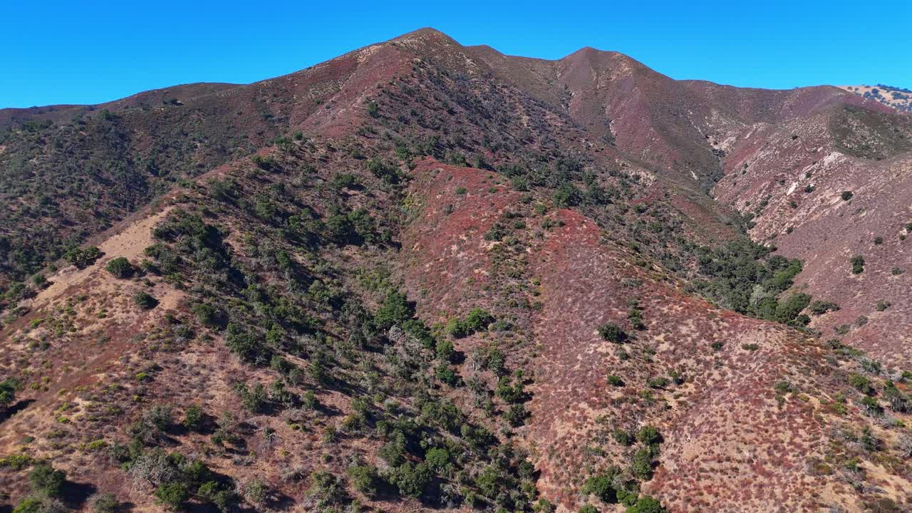 Dry mountain landscape in Salinas Valley with sparse trees and rugged terrain in aerila view