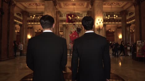 epic slow motion shot of two men in suits entering casino hall in monte carlo, monaco