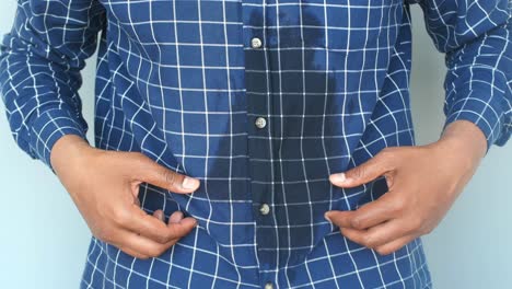 man with sweat stain on shirt