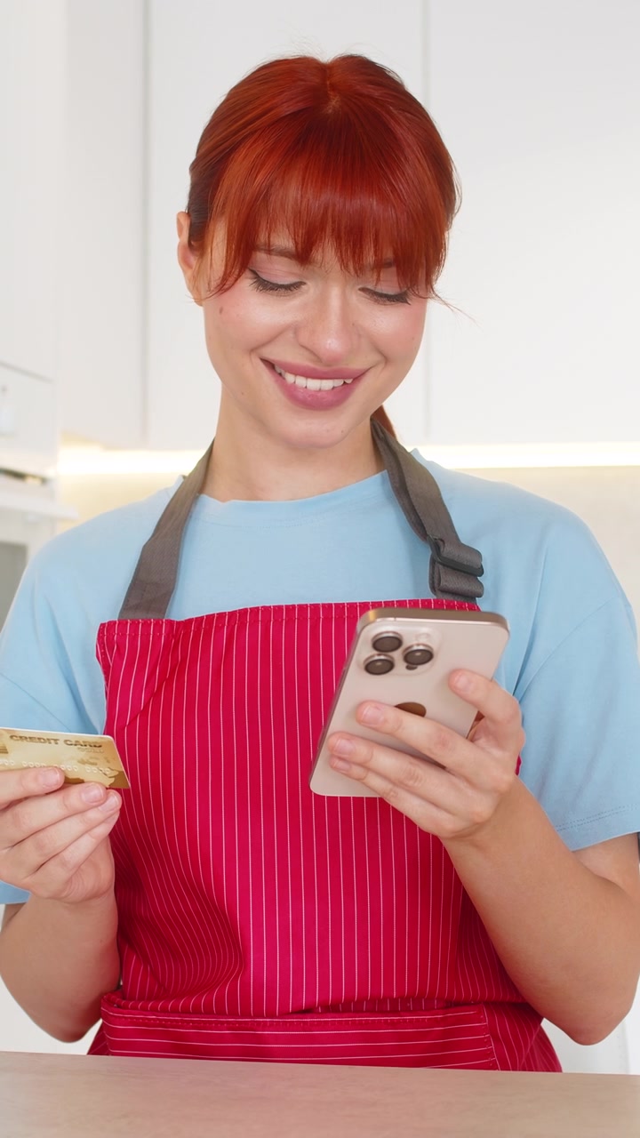 Young woman at bar checks grocery order on smartphone confirms payment with bank card approval done