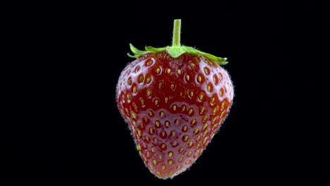 delicious strawberry rotates on a black background