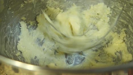 close up looking down at butter in a stand mixer being mixed