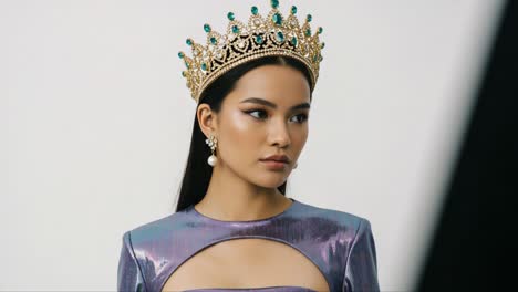 a captivating portrait of a miss pageant contestant exuding elegance in a shimmering outfit with a royal crown, showcasing beauty and poise in every frame