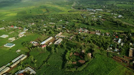 aerial view overlooking a small town, in kenya, africa - descending, drone shot