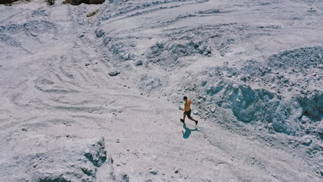 active runner jogging outdoor. aerial view of athletic young man running in the nature