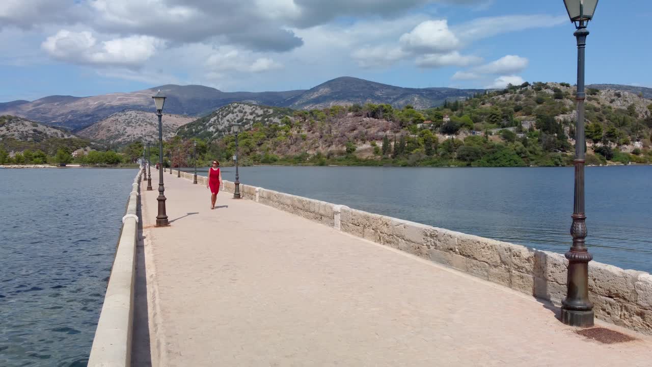 De Bosset Bridge in Argostoli city on Kefalonia island. Woman walking.