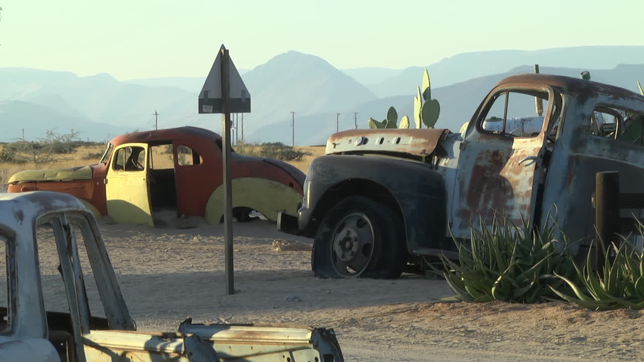 Collection Of Rusty Abandoned Cars In The Desert. Locked Off