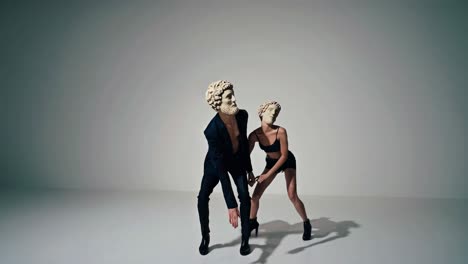 couple dancing in ancient greek statue masks