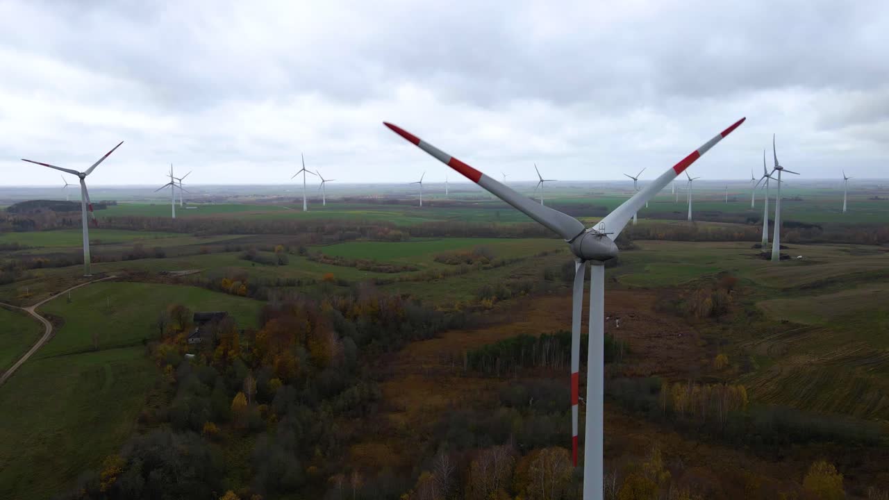 aerial view of clean and renewable wind power farm in motion converting kinetic energy modern electric industry environmental protection innovation ecosystem electricity generator wind turbines in 4k