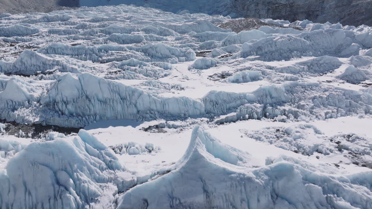 Aerial view of Everest Base Camp glaciers with shining white snow, sunny skies, Khumbu icefalls, and stunning Himalayan mountain scenery with dense snow covered lands at Himalayas Nepal Tourism