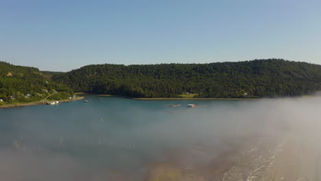 Scenic-aerial-view-of-fishing-weirs-in-a-harbor-along-the-rugged-Atlantic-Coast-on-a-foggy-summer-afternoon