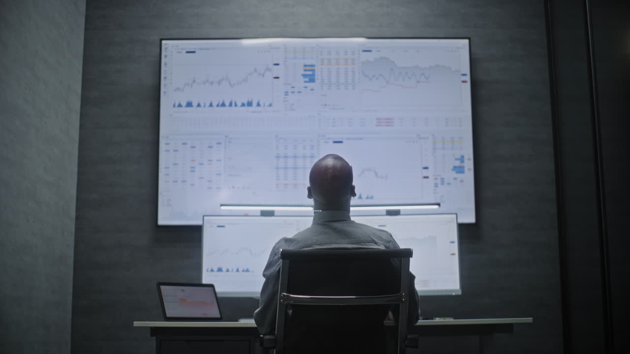 Businessman analyzing financial data in a dark office
