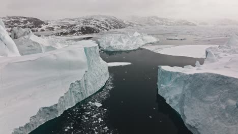 drone over sea and ice of ilulissat icefjord