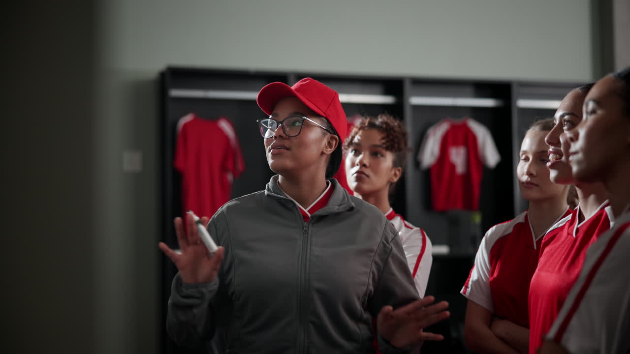 Soccer team coach explaining strategy on whiteboard