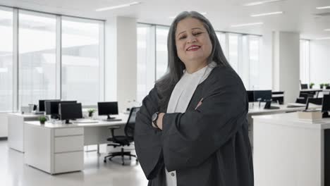 Portrait-of-Happy-Indian-senior-female-lawyer-standing-crossed-hands