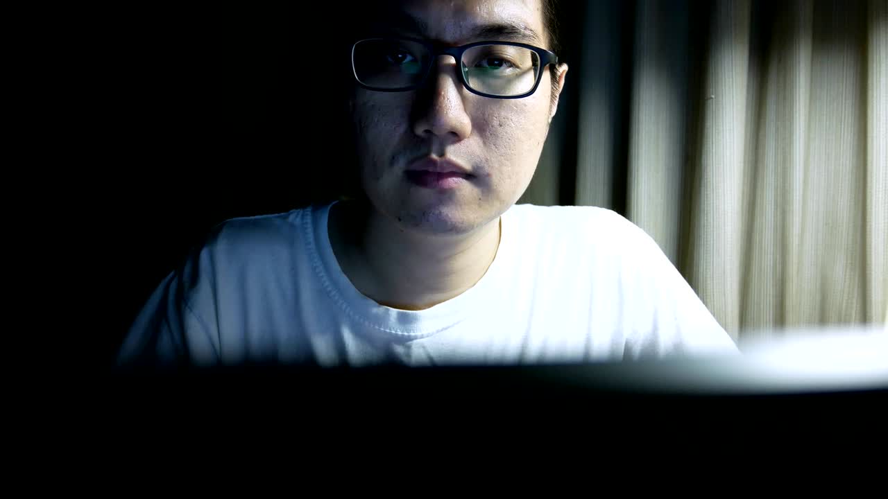 man working on laptop computer in the night - freelancer business working from home concept