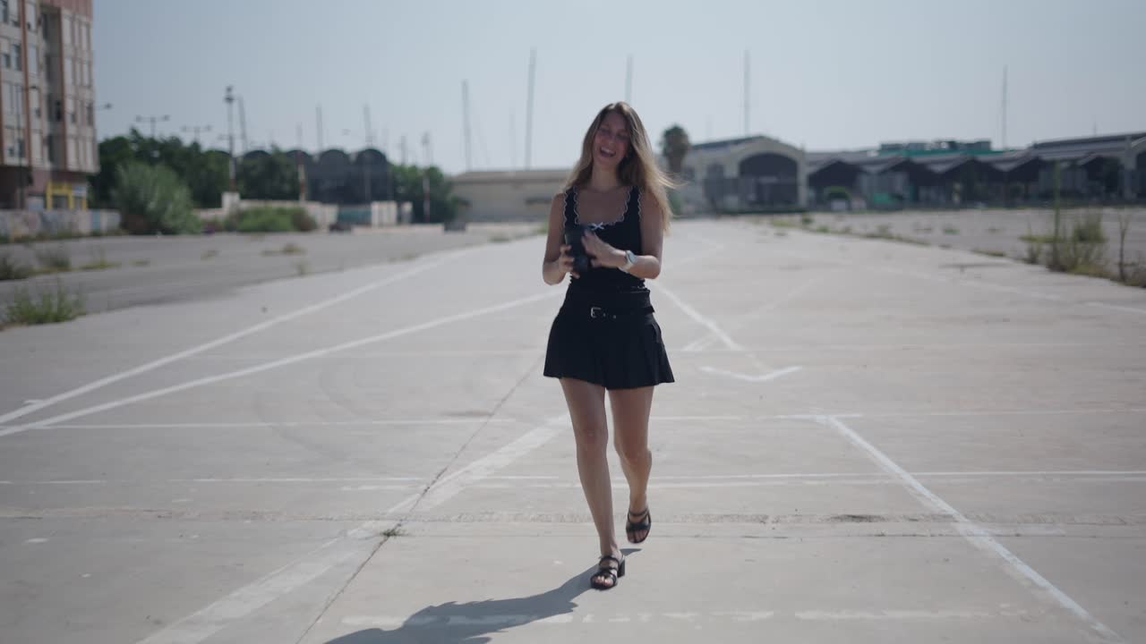 Young woman walking in a parking lot