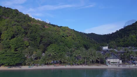 Magic-aerial-top-view-flight-Huts-Resort-Beach-Bungalows,-Jungle-hilly-Island-Thailand-2022