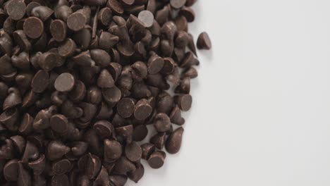 video of close up of multiple chocolate chip over white background