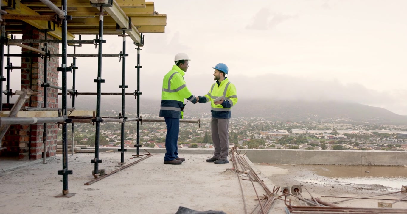 Construction Workers Discussing Project Plans on Building Site