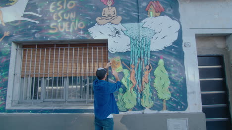 street artist drawing surreal graffiti outdoors in the city