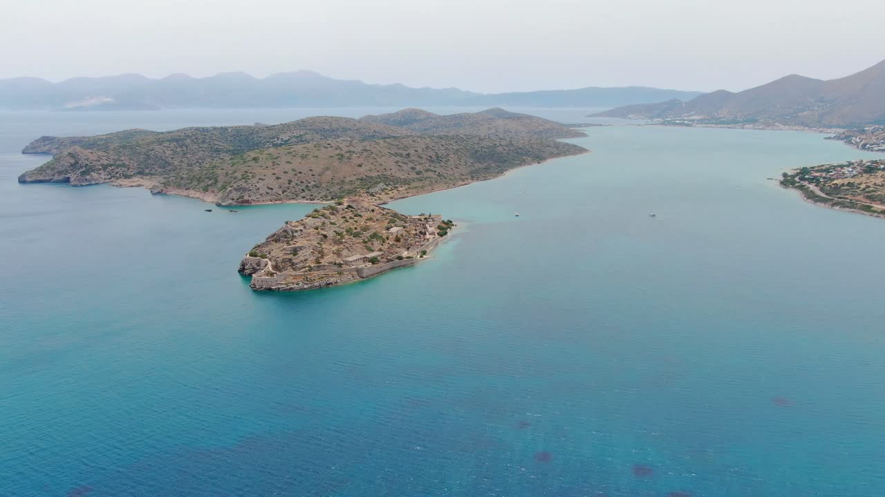 Aerial panoramic view of a chain of islands in a Mediterranean landscape with clear blue tropical water. Drone shot