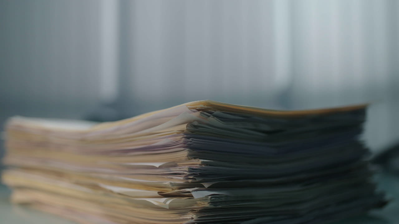 Stack of Papers Being Handled