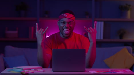 happy man working late on laptop