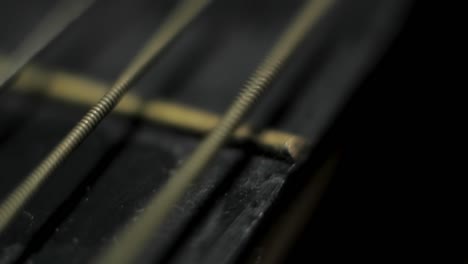 Moving-old-retro-dirty-antique-Guitar-string-vibrating-creating-wave-Macro