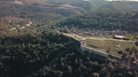 forward tilting drone shot over a hill with an archeological site in bulgaria