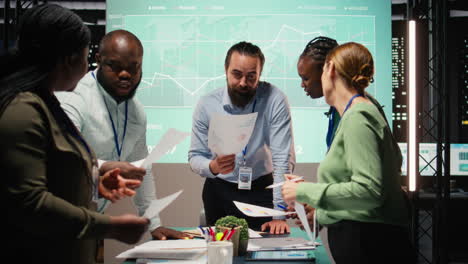 diverse group of professionals review files and performance metrics
