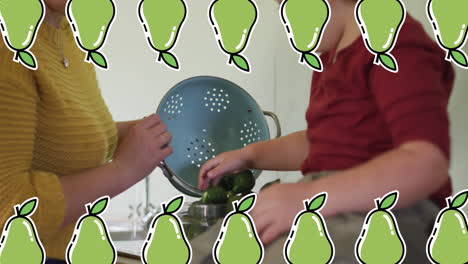 animation of pears icons over caucasian woman with son cooking