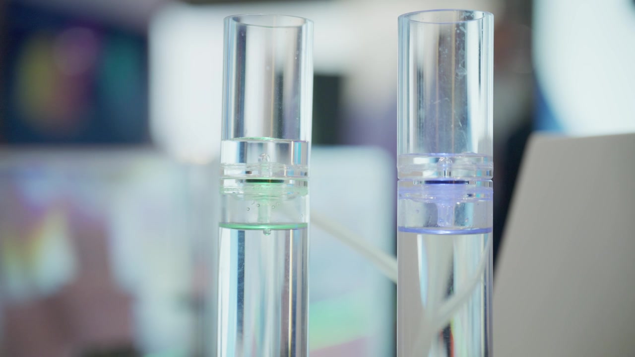 Scientific electrolysis setup with blue hydrogen and green hydrogen inspired lighting inside transparent reactor tubes during renewable energy testing