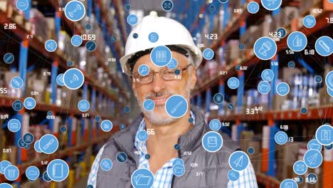 Animation-of-tech-icons-floating-over-happy-senior-caucasian-male-warehouse-worker