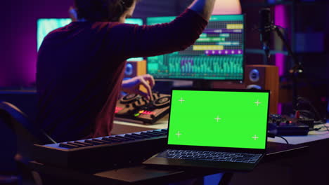 music engineer editing audio recordings on mixing console and daw software