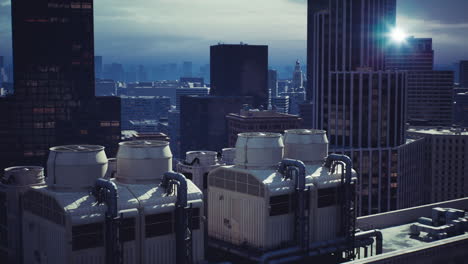 overview of city rooftops with industrial cooling towers in urban skyline