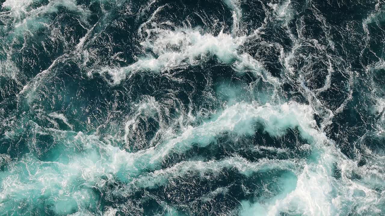 Blue waves of water of the river and the sea meet each other during high tide and low tide.