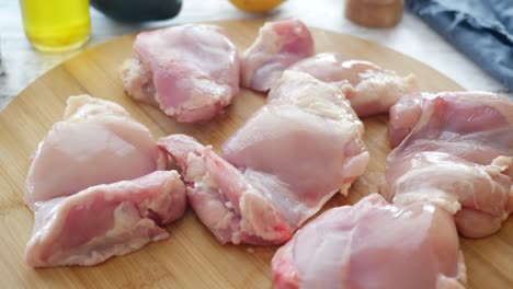 raw chicken thighs on a cutting board